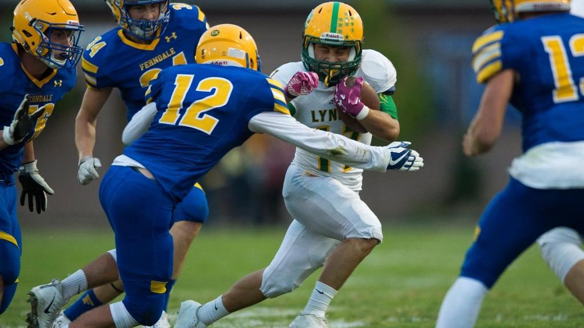 Lynden running back Eric Martin-Mann tries to avoid a tackle by Ferndale’s Jared Emmert during Friday’s game in Ferndale, won 19-16 by the Golden Eagles.