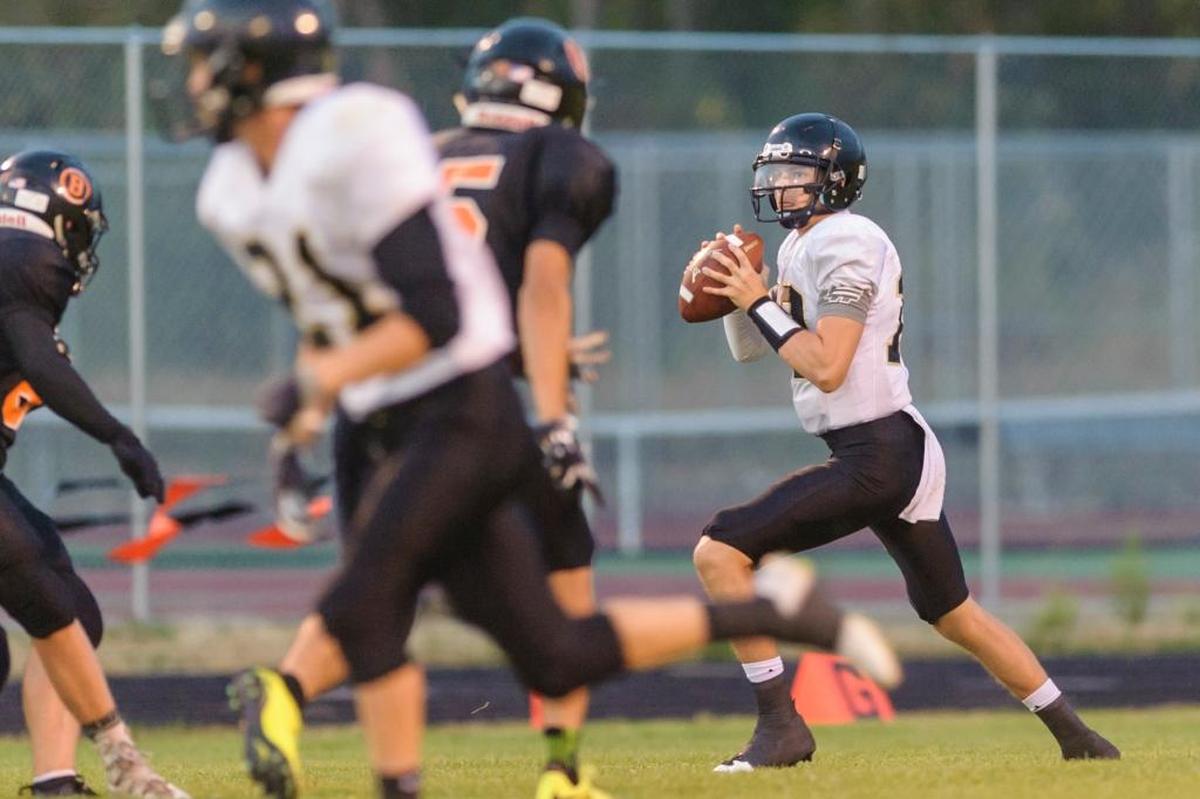 Meridian quarterback Simon Burkett looks for an open man against Blaine Sept. 8. Burkett leads Whatcom County with 1,466 yards passing.