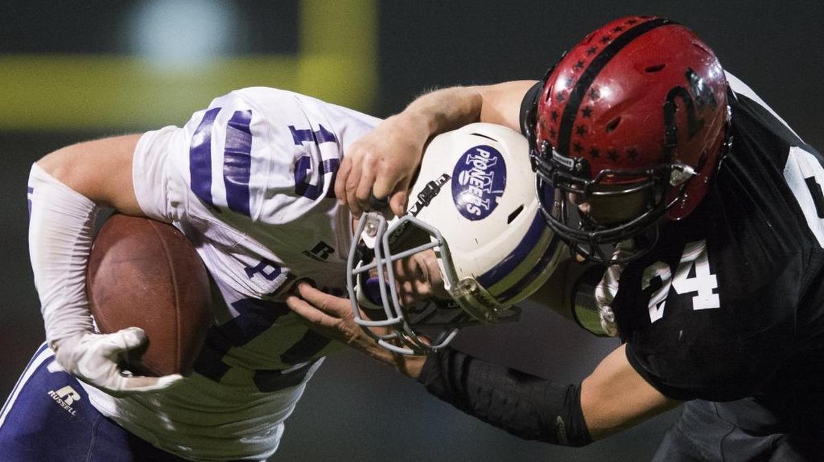Mount Baker’s Carson Engholm, right, tackles Nooksack Valley’s Austin O’Bryan Oct. 13.