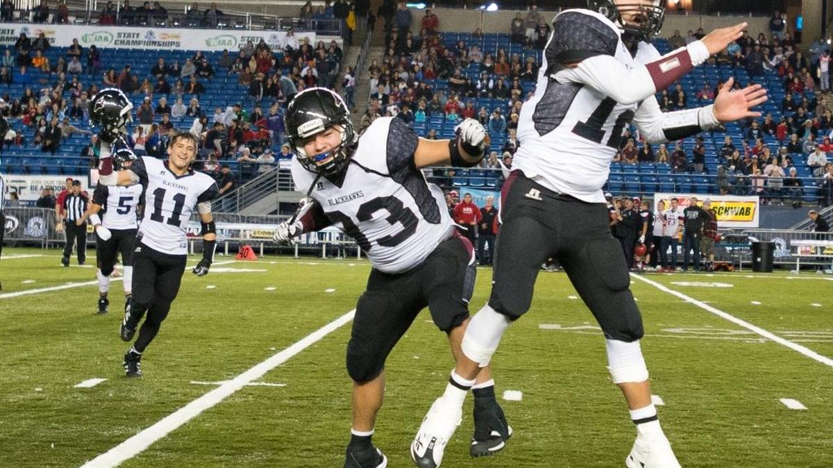 Lummi players, from right to left, Jonathan Casimir, Jeffrey Cultee, Free Borsey and Trazil Lane celebrate as the final seconds tick off the clock during a 26-20 victory over Neah Bay in a Class 1B State semifinal Friday, Nov. 27, at the Tacoma Dome in Tacoma.