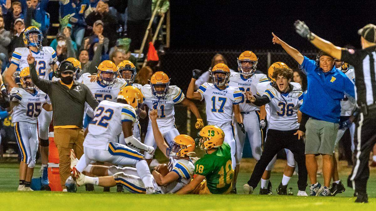 Ferndale defensive back Thomas Broselle (20) and the Ferndale bench celebrate an interception during the third quarter at Lynden High School on Friday evening Sept. 10, in Lynden. Ferndale defeated Lynden 35 to 25.