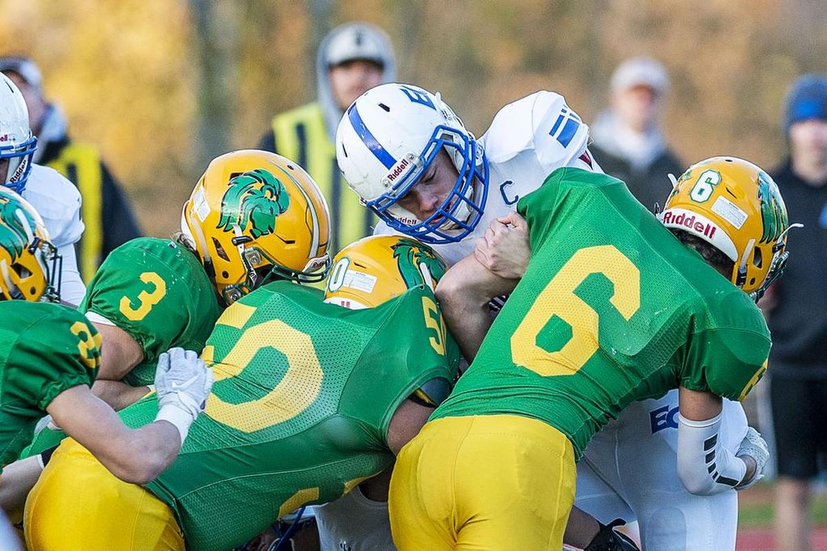 Eatonville quarterback Tristan Schoepf (16) gets crushed at the line of scrimmage by a slew of Lynden Lions for a loss of yardage in the first quarter of the 2A state playoff opener on Nov. 10 at Civic Stadium in Bellingham. Lynden defeated Eatonville 34-14 to advance.