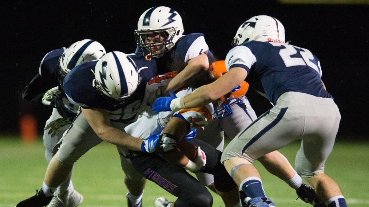 Rainier Beach’s Jerimiah Sio is swarmed by Squalicum players, from left to right, Damek Mitchell, Jack Wendling, Will Russell and Brian Pullman on Friday at Civic Stadium in Bellingham.