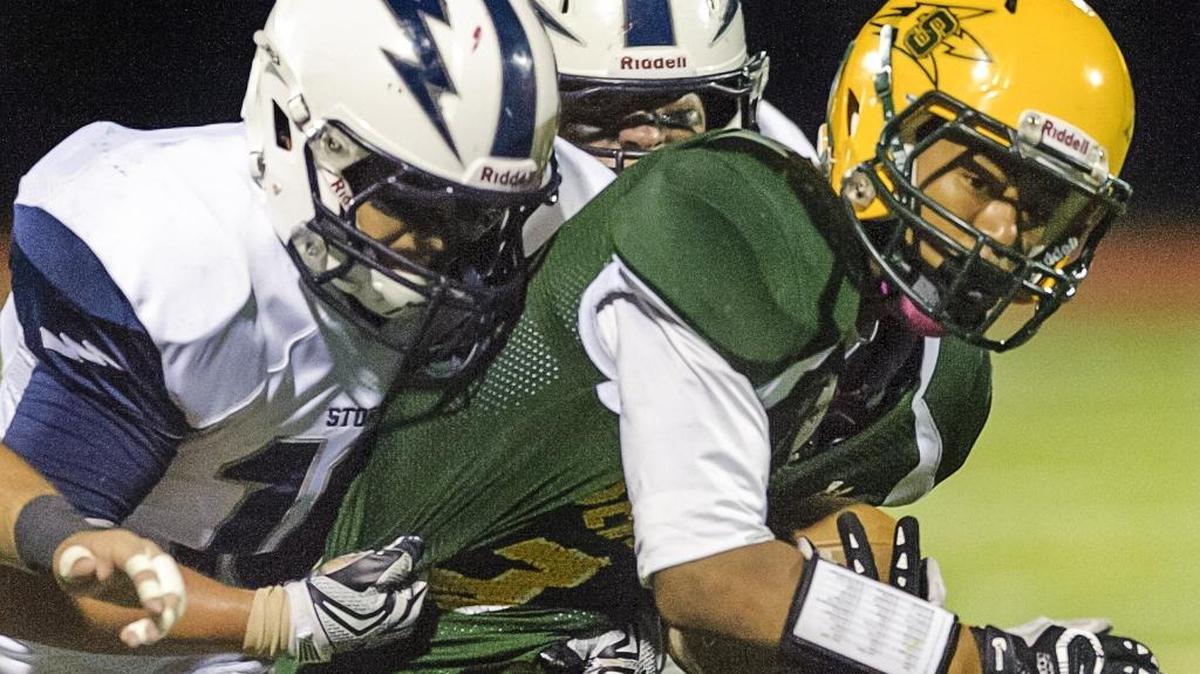 Sehome running back Daton Nestlebush gets stopped by Squalicum linebacker Creighton Kaui during the second quarter on Oct. 16, at Civic Stadium.