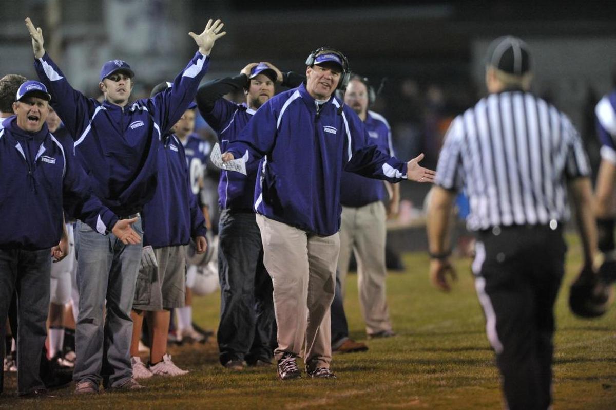 Nooksack Valley coach Robb Myhre, center, looks to the referee for a call during a 2012 game against Meridian.