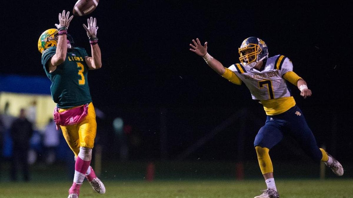Lynden’s Rylan Severson, left, hauls in a pass against Burlington-Edison’s Brett Rawlins for a touchdown Friday, Oct. 21, at Lynden High School.