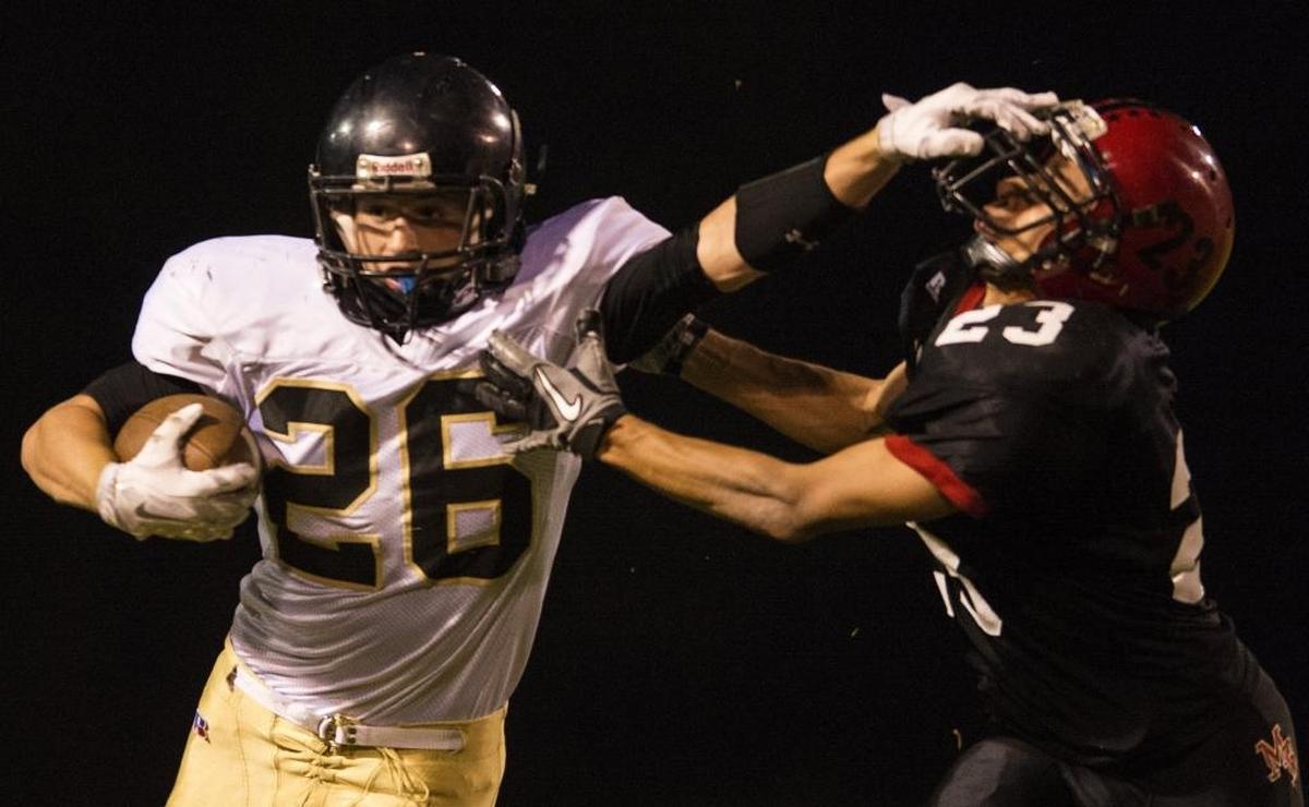 Meridian’s Nick Dritsas runs through an attempted tackle by Mount Baker’s Johnny Mata during the 2014 season.