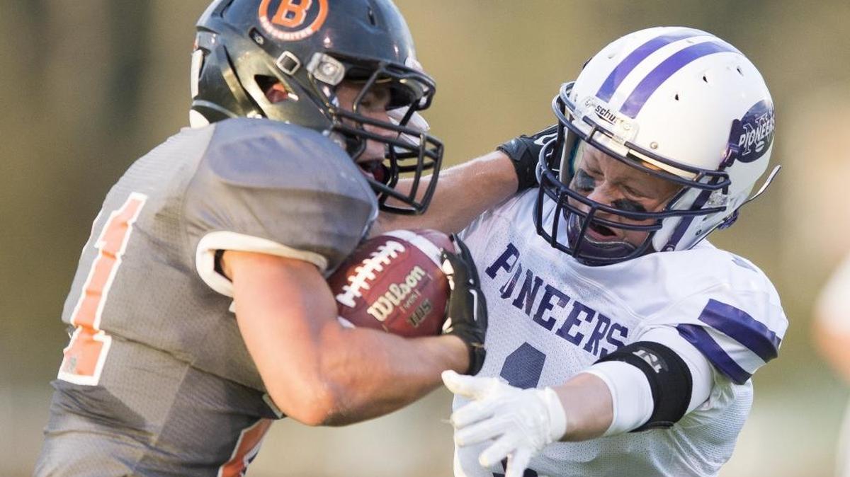 Blaine’s Riley Fritsch, left, stiff-arms Nooksack Valley’s Jeremy Dykes on Friday, Sept. 2, in Blaine.