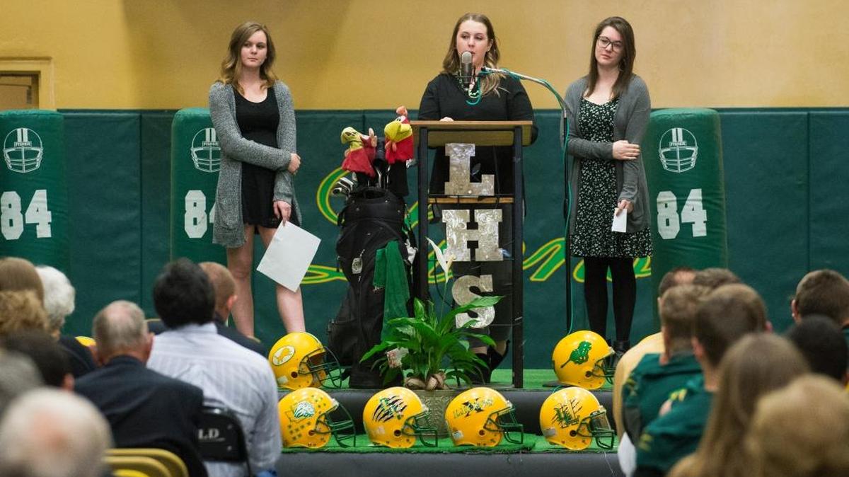 Curt Kramme’s daughters, from left to right, Maddie Kramme, Alayna Haynie and Zoe Kramme speak at his memorial service on Saturday, May 6, at Lynden High School.