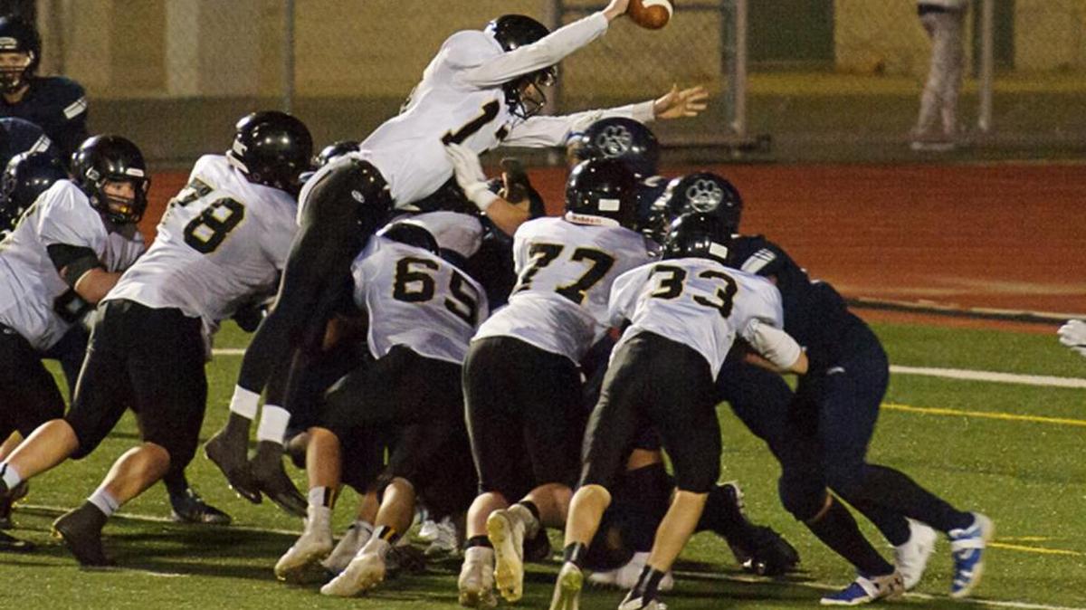 Simon Burkett dives over the line for a touchdown during Saturday’s Class 1A state playoff game against Cascade Christian at Sumner.
