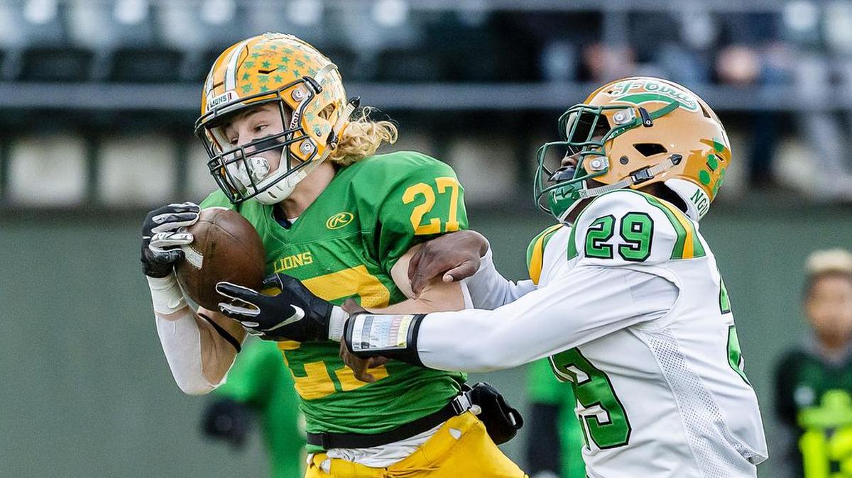 Tumwater defender Turner Allen (29) attempts to break up a pass intended for Lynden wide receiver Grant Vander Yacht (27) as he comes down with it for a touchdown Saturday early in the first quarter during the 2A state playoffs at Civic Field in Bellingham. The touchdown and resulting extra point gave Lynden an early 7-0 lead. Lynden defeated Tumwater 28-27.