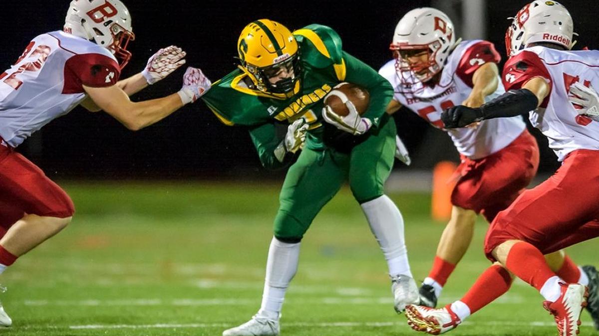 Sehome running back Ryan McDonnell (21), center, is stopped at the line of scrimmage by Bellingham’s Ethan Fields (22), left, Jade Dudoward (50), and Bram VanWoerden (54) during the second quarter on Friday evening Oct. 6, 2017, at Civic Stadium in Bellingham, Wash.