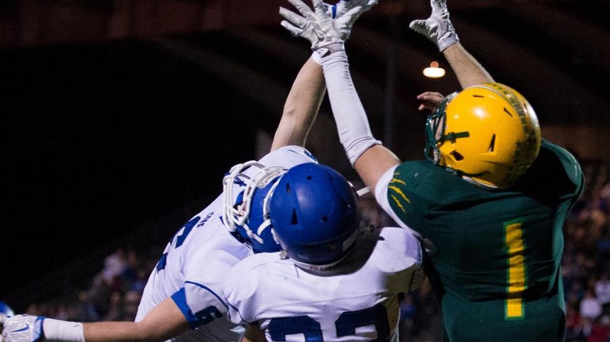 Sedro-Woolley's Spencer Hoover and Bryce Hornbeck defend a pass to Lynden's Jordan Wittenberg on Friday, Nov. 6, at Civic Stadium in Bellingham.