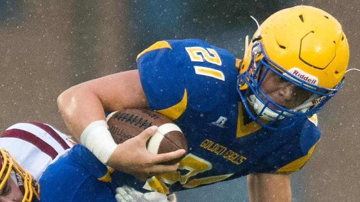 Ferndale’s Cole Semu drags two Capital defenders Nov. 5 at Civic Stadium in Bellingham. Semu has become the featured running back for Ferndale this year and scored five touchdowns in Week 1.