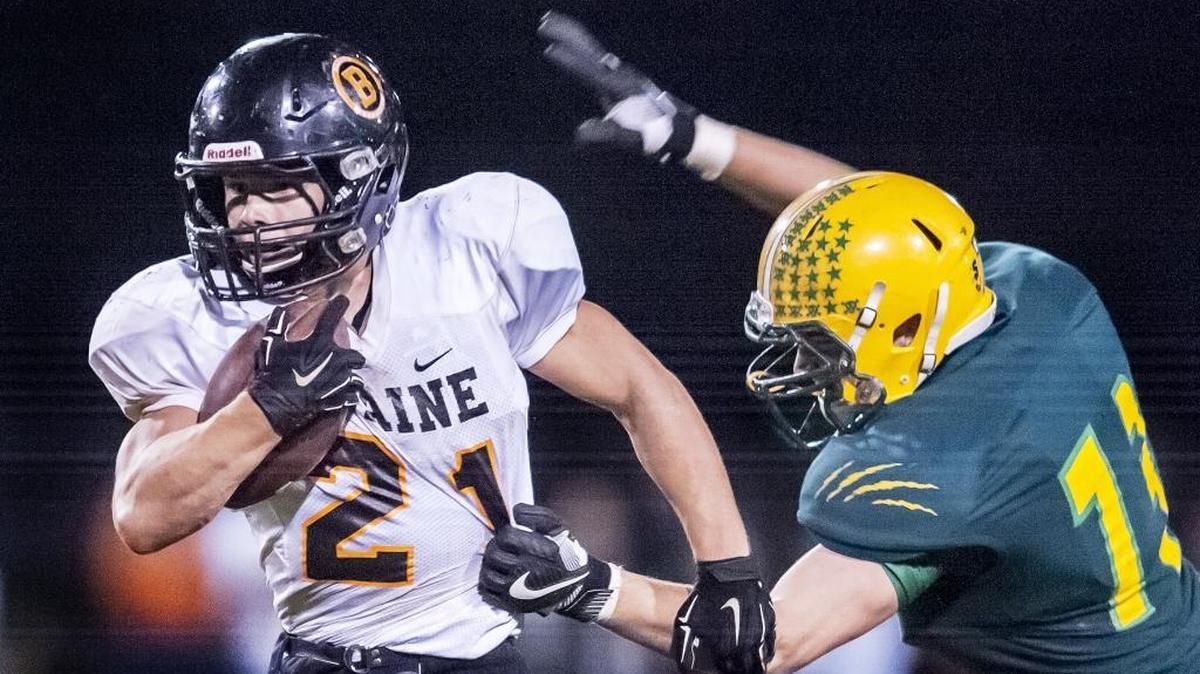 Blaine’s Riley Fritsch slips through the hands of Lynden’s Jacob Kettels at the line of scrimmage during the second quarter Oct. 7 at Lynden High School.