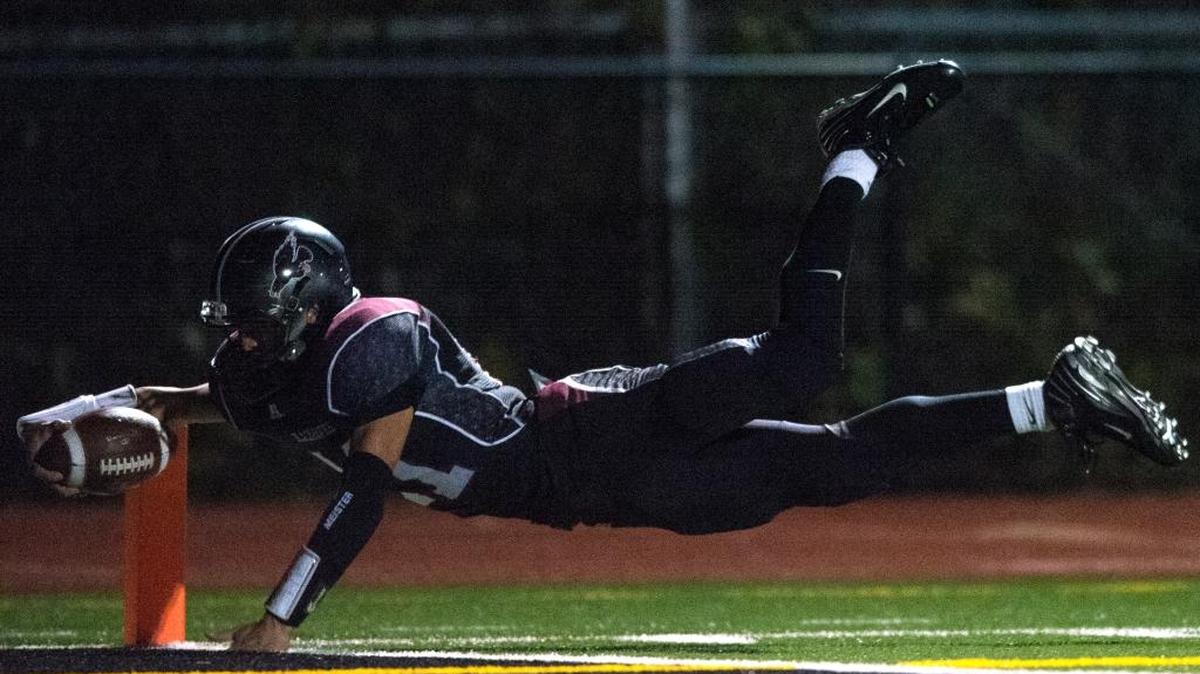 Lummi’s Free Borsey dives into the end zone for a touchdown against Naselle on Friday, Nov. 18, at Lummi Nation School.