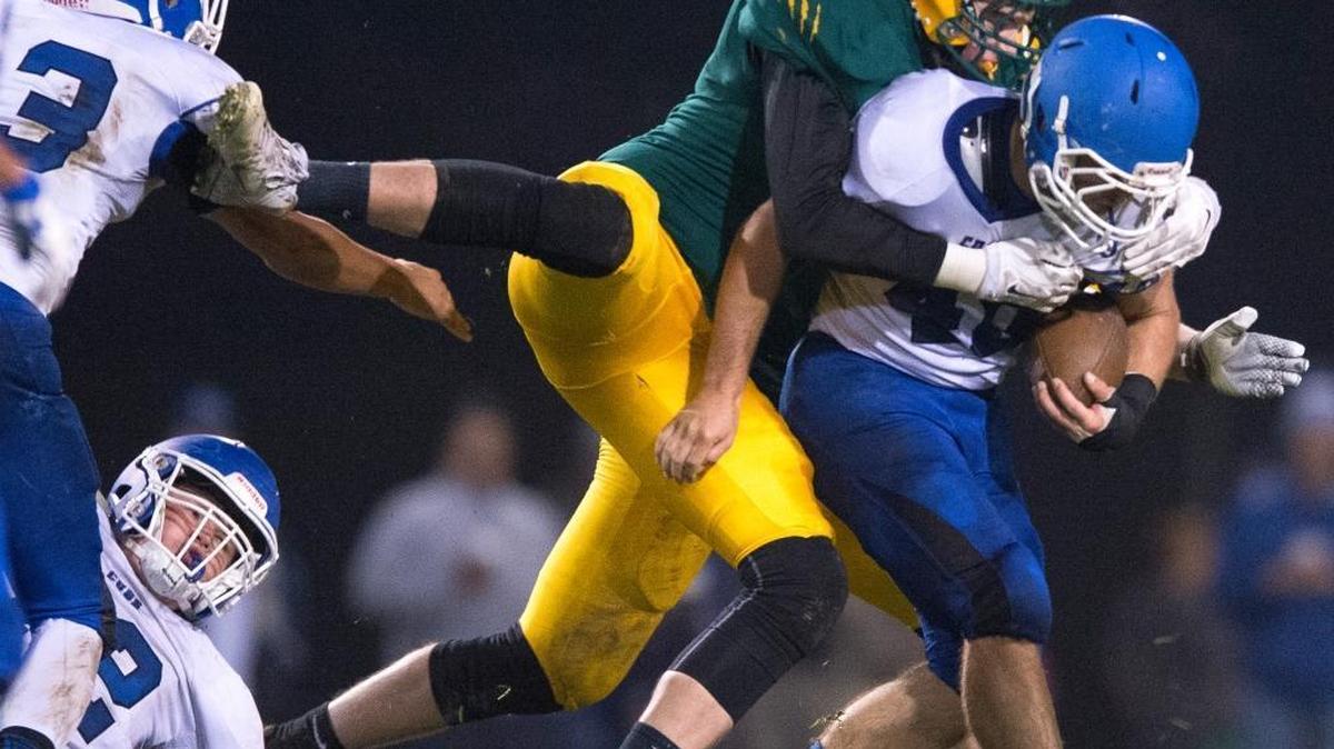 Lynden's Davis Bode clings to the back of Sedro-Woolley's Quinn Carpenter during a 32-29 loss in overtime on Friday, Oct. 23, in Lynden.