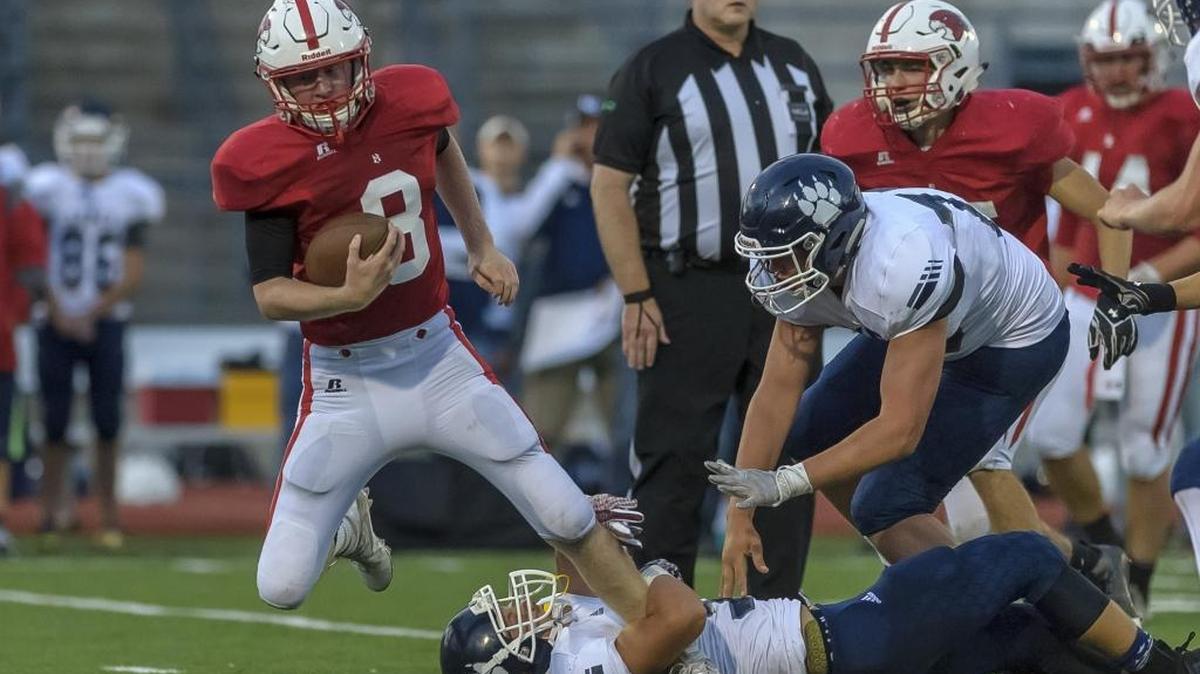 Bellingham quarterback Nick Knutson fights for yardage against Lynden Christian Sept. 2 at Civic Stadium.