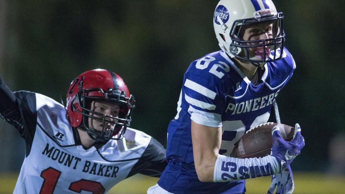 Nooksack Valley’s Jordan Veening, right, runs into the end zone after making a catch, as Mount Baker’s Kaleb Bass attempts to tackle him during a 26-14 victory Friday, Sept. 22.