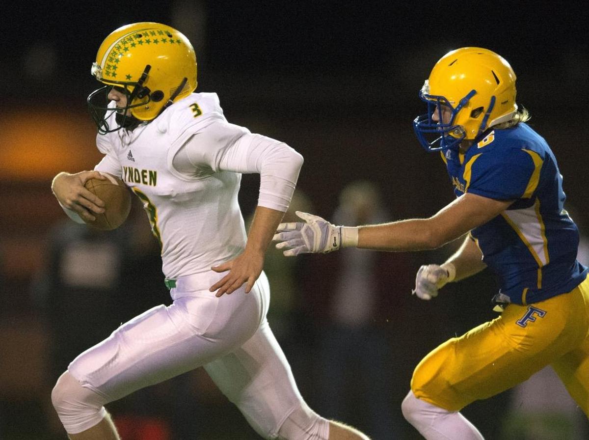 In addition to being a threat as a runner, Lynden’s Sterling Somers, left, leads the Northwest Conference with 1,289 yards passing this season.