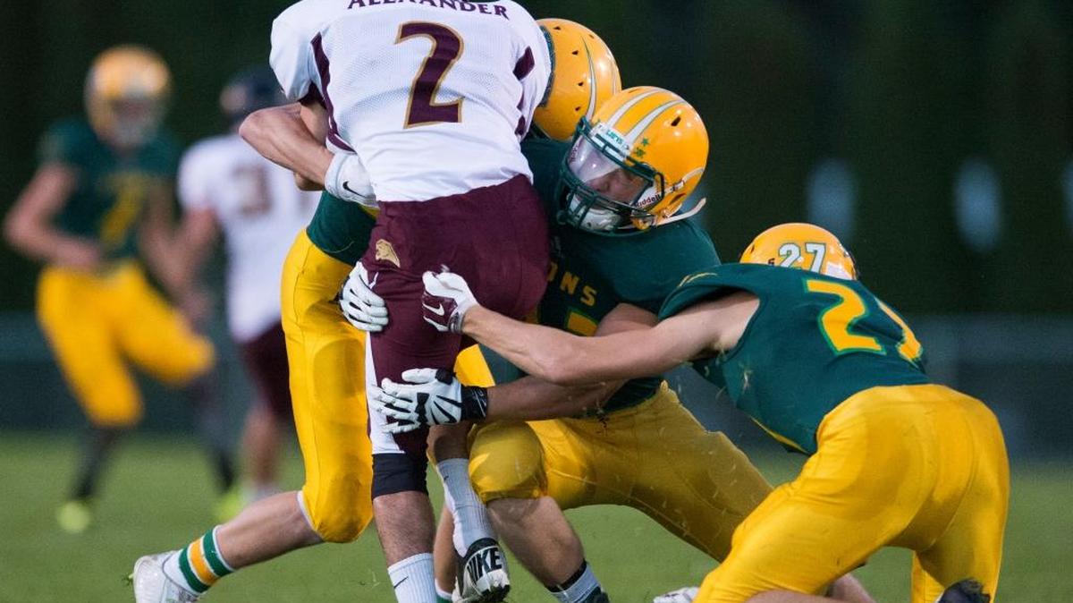 
A group of Lynden players gang tackle a Lakewood running back on Friday, Sept. 11, at Lynden High School
