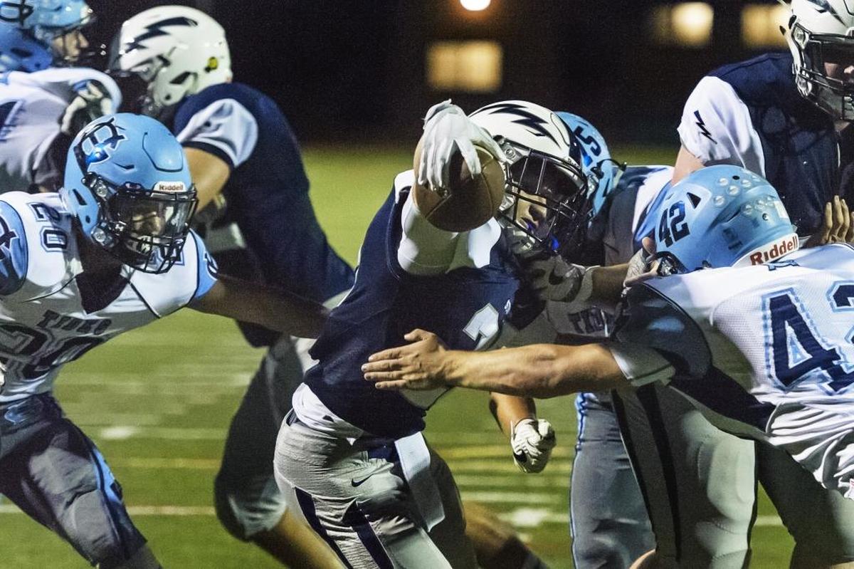 Squalicum’s Tristen Smith reaches for a touchdown between Gig Harbor’s Jake Bruess, right, and CP Loughren Sept. 1 at Civic Field. Smith leads Whatcom County with 1,030 yards rushing through the first four weeks of the 2017 season.