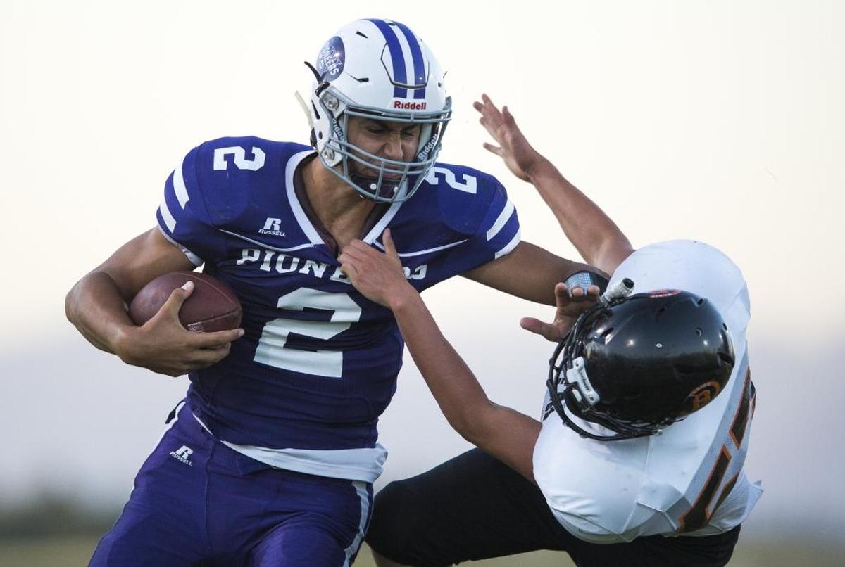 Nooksack Valley’s Casey Bauman, left, stiff-arms Blaine’s Mason Vega during a 45-6 victory for the Pioneers Sept. 1. Bauman leads Whatcom County with 223 yards passing after Week 1.