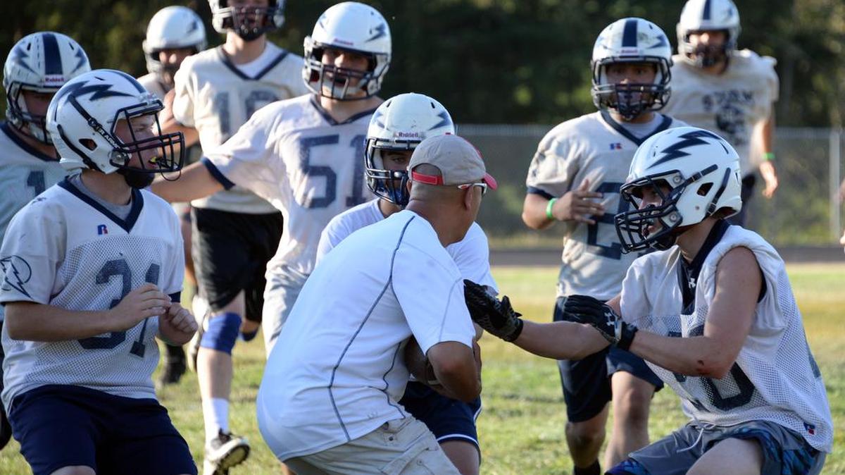 
Squalicum players break down in front of a member of the Storm’s coaching staff during a defensive pursuit drill Wednesday, Aug. 19, at Squalicum High School. Football practice for all 11 Whatcom County schools opened Wednesday
