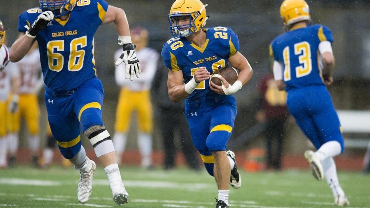 Ferndale’s Ben Broselle (20) follows a block from teammate Geirean Hatchett on Saturday, Nov. 5, in a 3A quad-district game against Capital.
