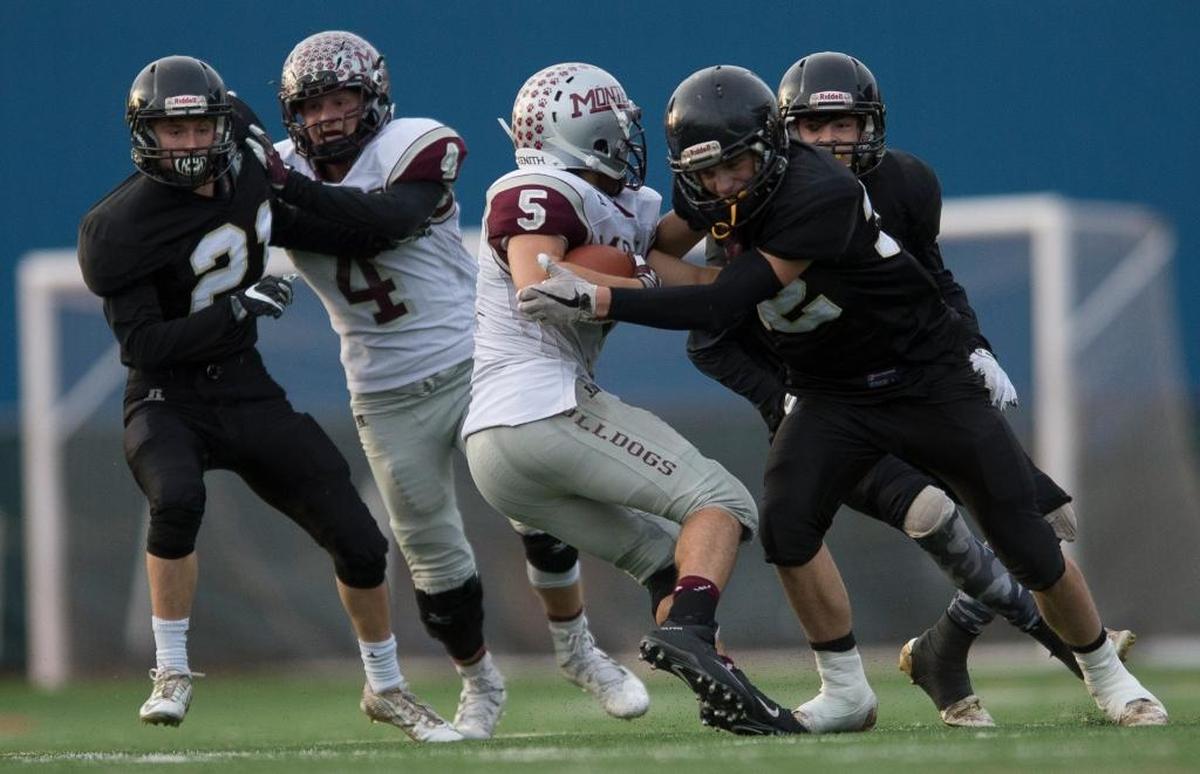Meridian’s Tony Schleimer leads a charge of Trojans defenders corraling Montesano’s Teegan Zillyett during the Class 1A state quarterfinals on Saturday, Nov. 18, at Civic Stadium in Bellingham.