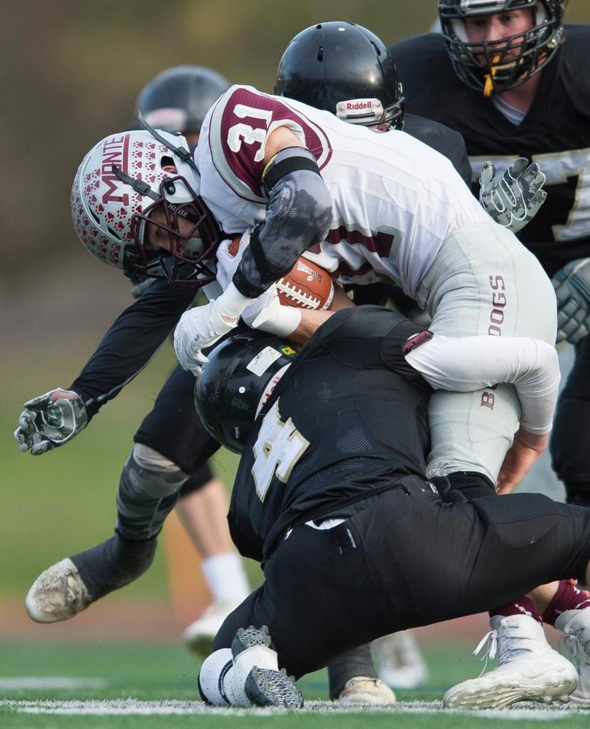 Meridian’s Jake Cheney brings down Montesano’s Carson Klinger during the Class 1A state quarterfinals on Saturday, Nov. 18, at Civic Stadium in Bellingham.