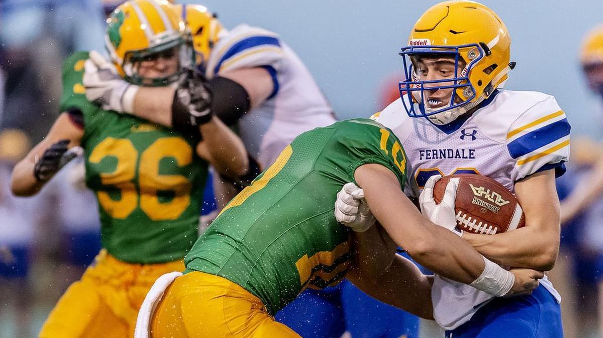 Ferndale running back Jaden Brown (36) is stopped by Lynden defensive back James Marsh (10) after a short gain early in the first quarter during a rainy Friday evening Sept. 7, 2018, at Lynden High School in Lynden, Wash. Lynden defeated Ferndale 30-6.
