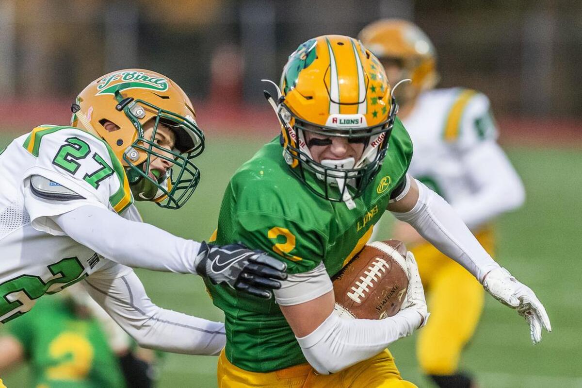 Lynden wide receiver Kobe Elsner (2) evades Tumwater defender Patrick Williams (27) at the line of scrimmage to earn the first down Saturday in the second quarter during the 2A state playoffs at Civic Field in Bellingham. Lynden defeated Tumwater 28-27.