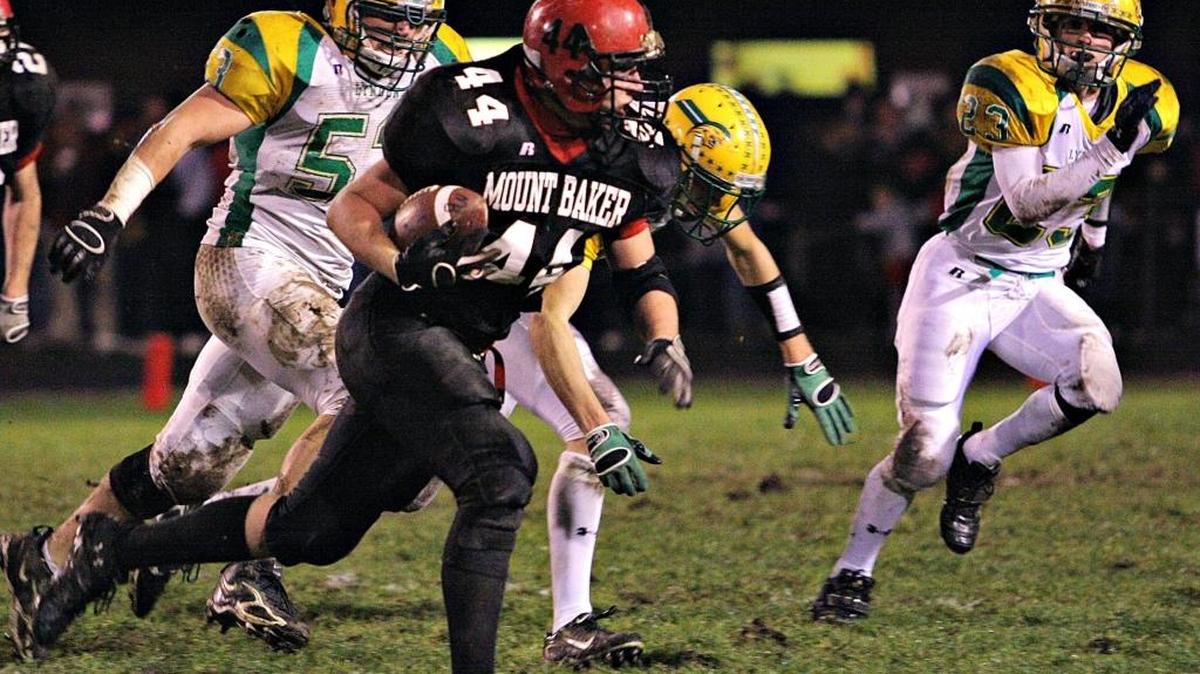 Mount Baker’s Gage Robinson runs the ball as Lynden's defense approaches during a game in 2007 at Bob Tisdale Field. The Mountaineers’ new grass football playing surface is nearly ready and will host the Sept. 29 1A NWC game against Lynden Christian.