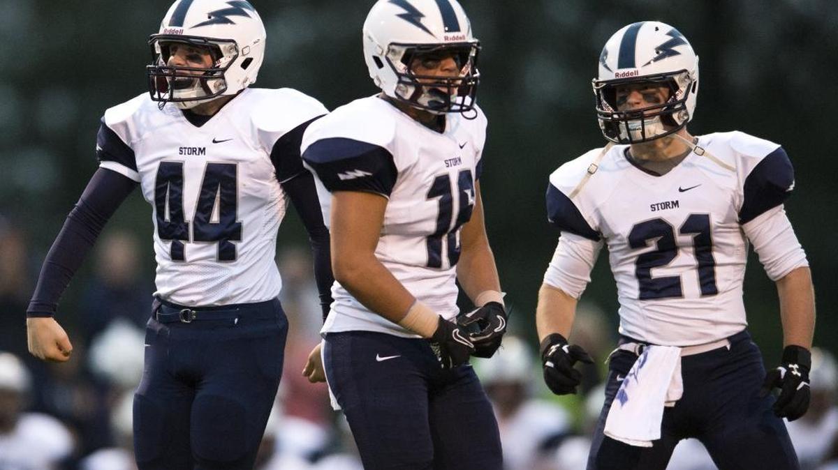 Squalicum’s Jack Wendling, Creighton Kaui and Jake Burns celebrate a stop on defense on Sept. 18, against Lynden.