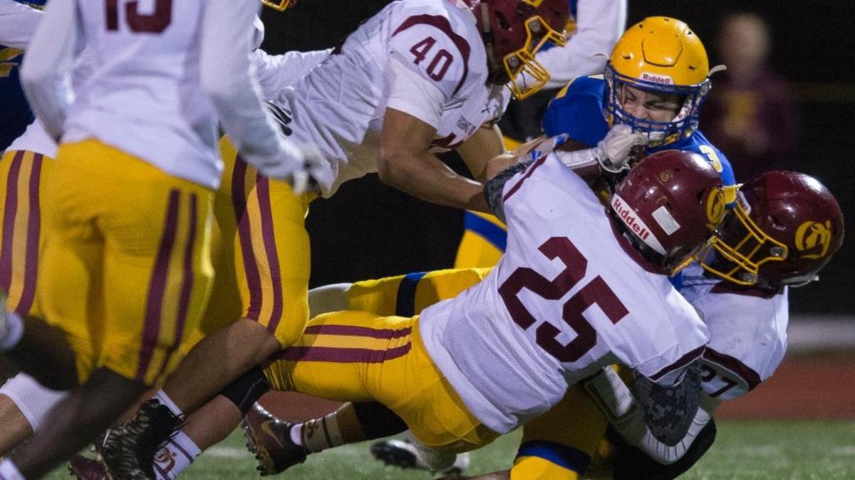 Ferndale's Connor Obergottsberger is brought down by O’Dea's Styles Siva-Tu’u, Henry Muench and Parker D'anna during a kickoff return in the Class 3A state quarterfinals on Friday, Nov. 17, at Civic Stadium in Bellingham. O'Dea defeated Ferndale 42-14.