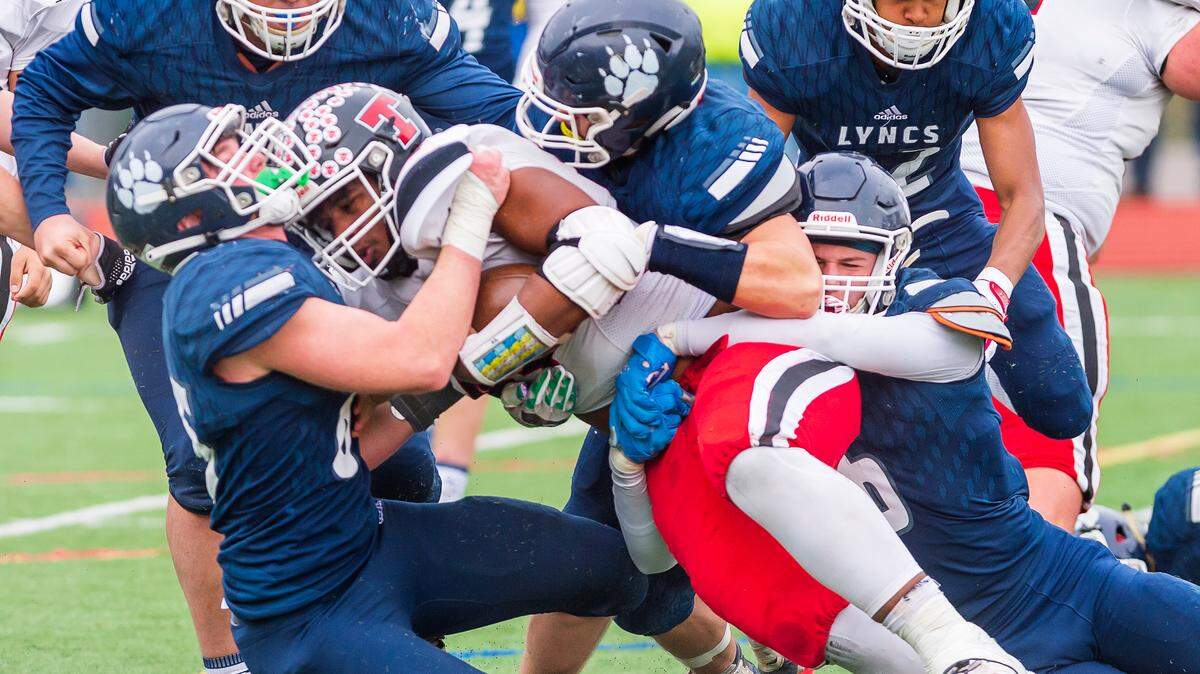 The Lynden Christian defensive line stops Tenino running back Takari Hickle (44) at the line of scrimmage during the fourth quarter on Saturday afternoon Nov. 20, 2021, at Civic Stadium in Bellingham, Wash. Lynden Christian defeated Tenino 49 to 18 to advance to the semi-finals.