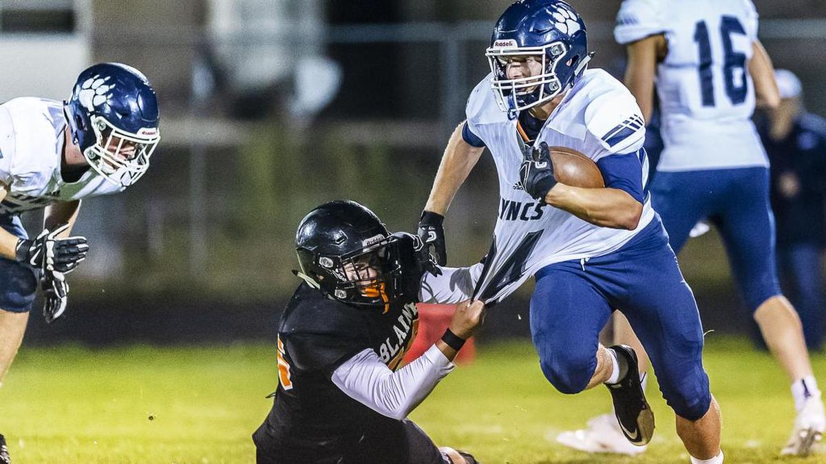 Blaine defensive lineman Gavino Rodriquz (56) takes down Lynden Christian running back Levi Korthuis (24) for a short loss during the second quarter on Friday evening, Sept. 14, 2018, at Blaine High School in Blaine, Wash. Lynden Christian defeated Blaine 14-3. During a special halftime ceremony, the 1978 Blaine state championship team was honored and the jersey of quarterback Curt Kramme was retired. Kramme was also a hall-of-fame coach for the Lynden Lions.
