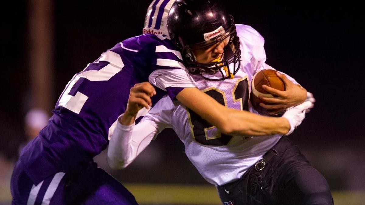 Nooksack Valley’s Jordan Veening, left, tackles Meridian’s TJ Dykstra after a completed pass Friday, Sept. 30, in Everson. Nooksack Valley High School won 47-34.