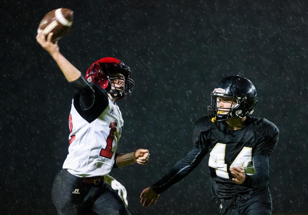 Meridian’s Bryson Hickok, right, puts pressure on Mount Baker’s Kaleb Bass as he throws Oct. 6 in Laurel.