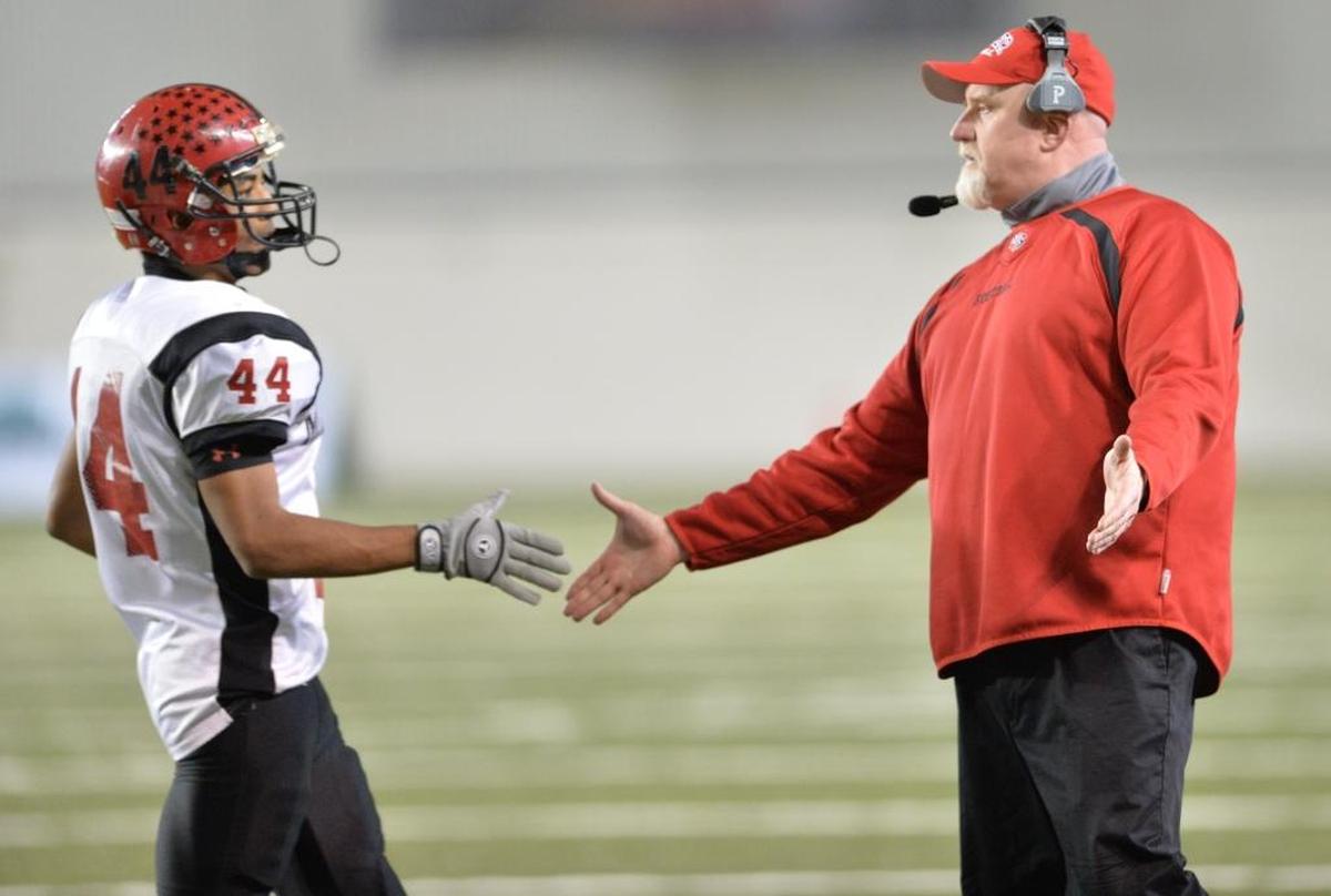 Mount Baker coach Ron Lepper, congratulates Izaiha Schwinden during the Mountaineer’s 2013 Class 1A state semifinal win over Cascade Christian at the Tacoma Dome.