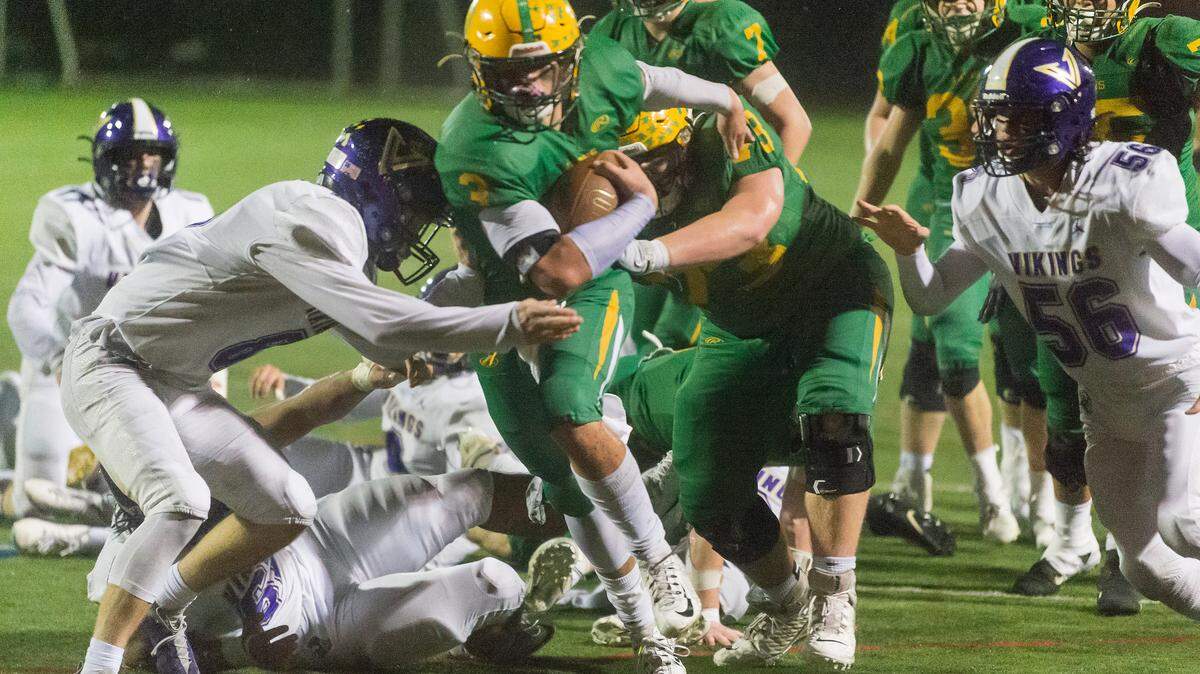 Lynden tight end Cade Slayton (3) breaks through the line of scrimmage as North Kitsap defensive backs Logan Sloman (8), left, and William Staley (56) move in to stop Slayton half a yard from the goal line late in the fourth quarter during the 2A state football semi-final playoff on Saturday afternoon Nov. 27, 2021, at Civic Stadium in Bellingham, Wash. Lynden North Kitsap 15-10 to advance to the state final.