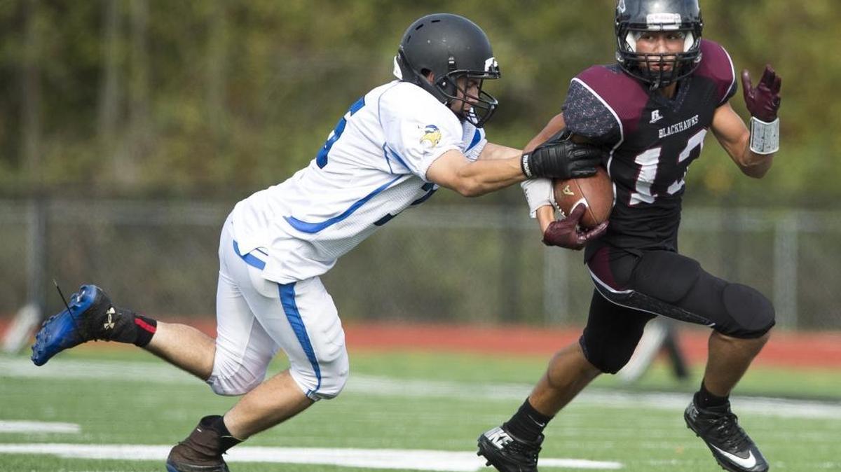 Lummi’s Raven Borsey, right, breaks a tackle by Orcas Island’s Garret Ballinger on his way to a touchdown Sept. 24 at Lummi Nation School.