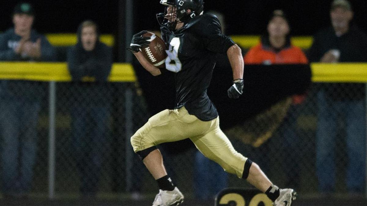 Meridian’s Bryce Vandenhaak takes a short pass 85 yards for a touchdown against Nooksack Valley on Friday, Sept. 29, in Laurel.