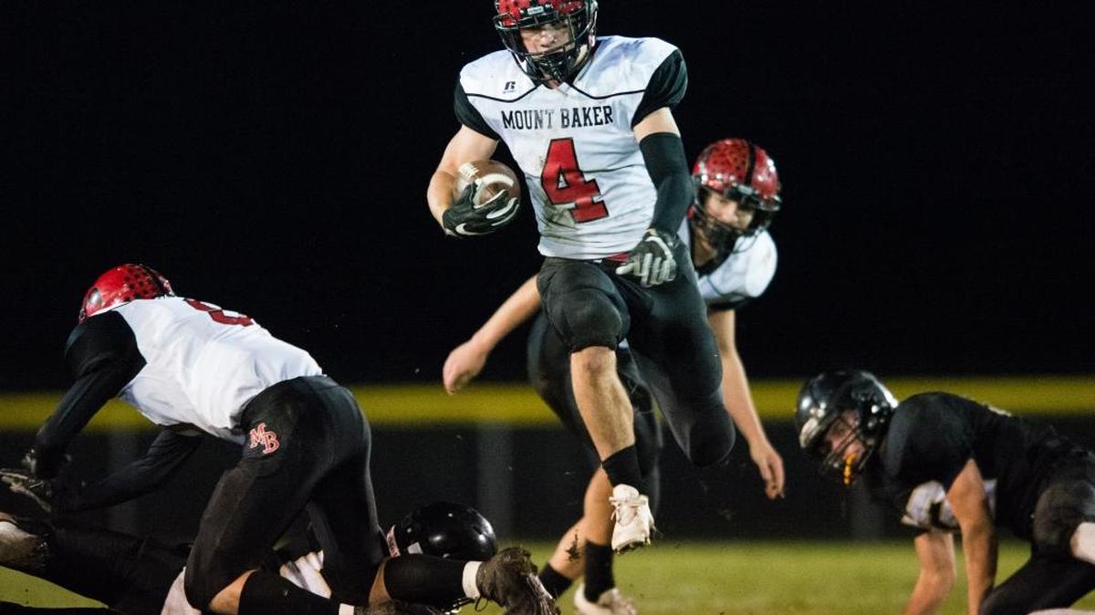 Mount Baker’s Jed Schleimer hurdles a Meridian defender on Friday, Oct. 28, in Laurel.