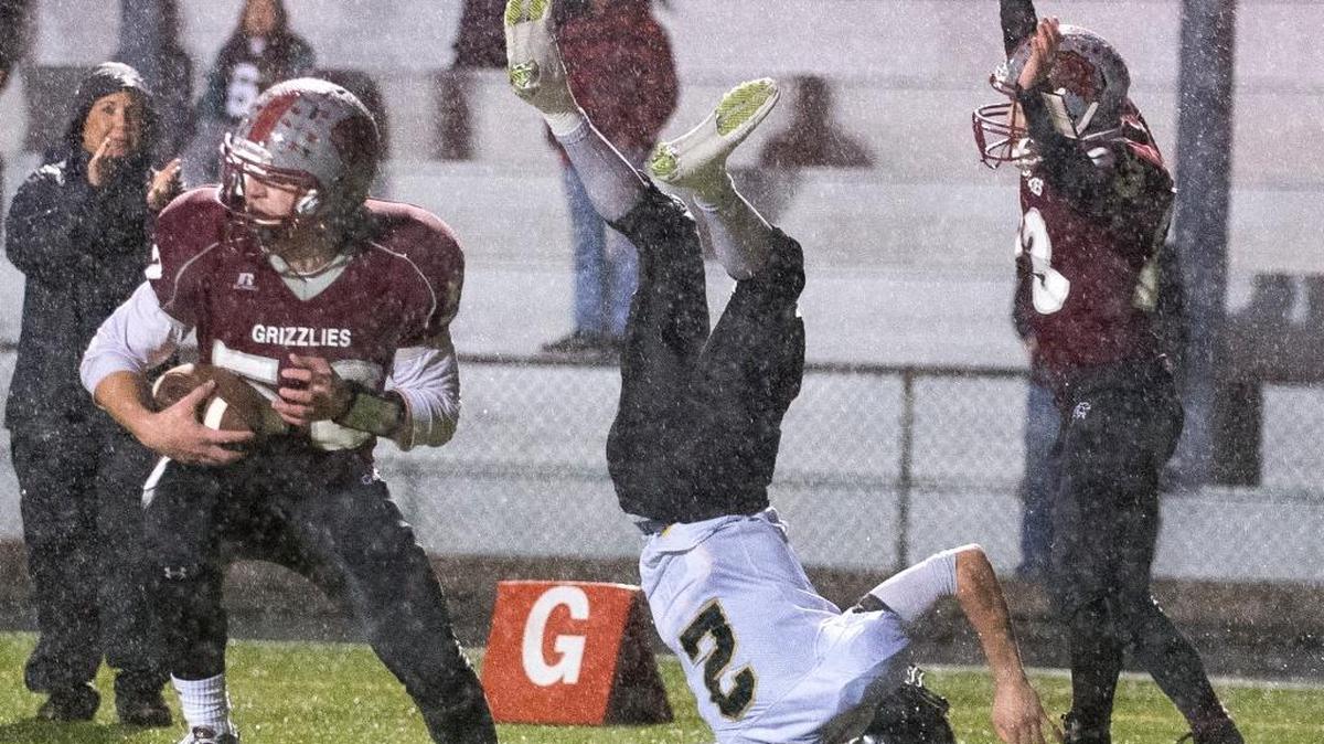 Hoquiam's Jordan Sears, left, intercepts a pass intended for Meridian's Marcus McGuinn, center, on the decisive play of a Class 1A State Football Playoff game on Saturday, Nov. 24, at Stewart Field in Aberdeen. Hoquiam won the game 25-20.
