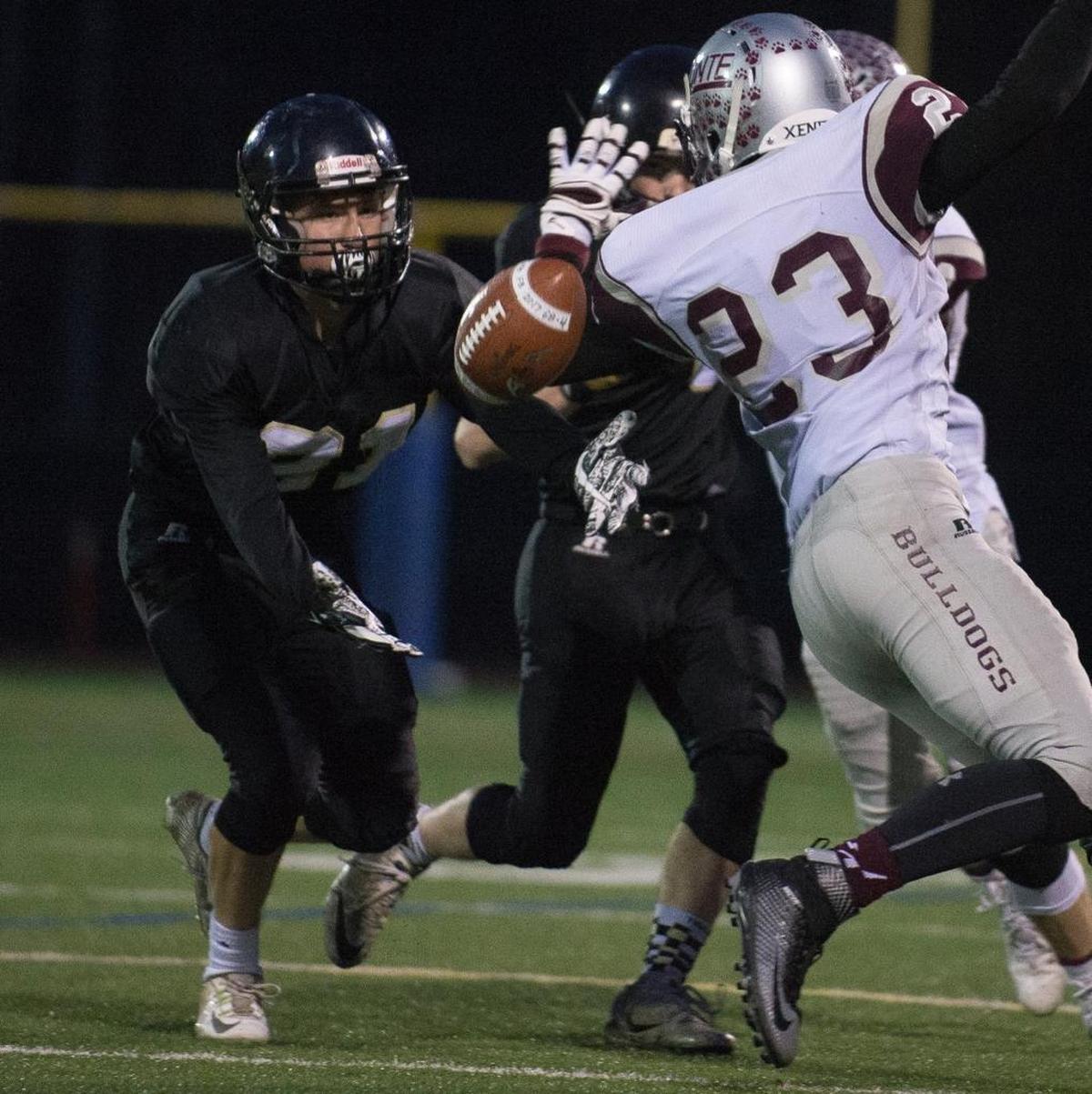 Meridian’s Lukas Hemenway intercepts a pass intended for Montesano’s Kooper Karaffa, right, in the Class 1A state quarterfinals Saturday, Nov. 18, at Civic Stadium in Bellingham.