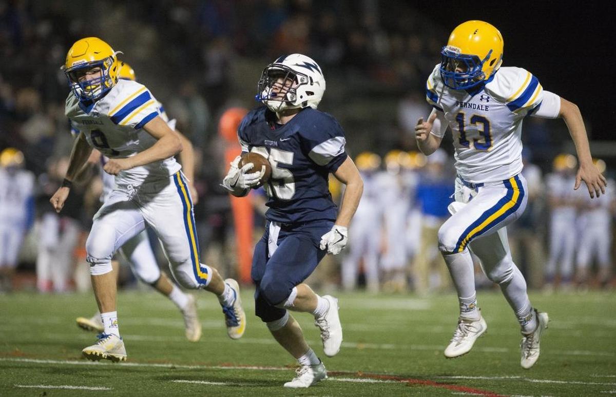 Squalicum’s Triston Smith, center, runs past Ferndale’s Justice Powell, left, and James Hinson for a 38-yard touchdown Oct. 22. Smith leads Whatcom County with 745 yards rushing this season.