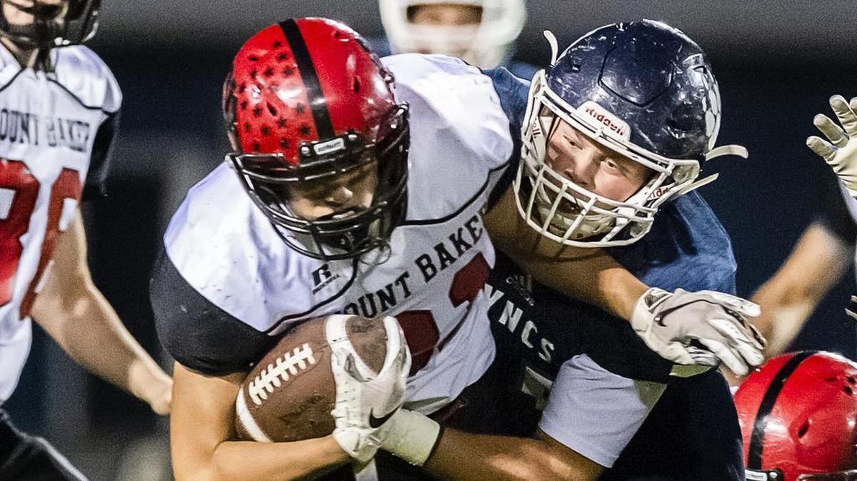 Mount Baker running back Jason Lee gets pulled down by Lynden Christian linebacker Dylan Kaemingk after a short gain during the first quarter Friday evening, Oct. 12, 2018, at Lynden Christian High School in Lynden, Wash. The visiting Mount Baker defeated Lynden Christian 20-14.