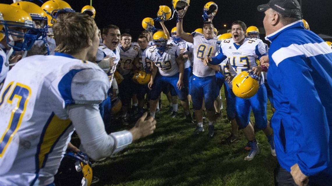 Ferndale players greet coach Jamie Plenkovich in the end zone after beating Lynden in 2014. Ferndale will move to the Wesco league in 2016.